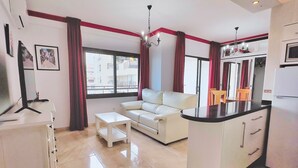 A modern apartment with a living room, a dining area, and a kitchen. - Mediterraneo 702. Super Studio with Amazing Sea Views (Marbella)