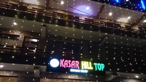 A building with a sign reading "KASAR HILL TOP" and multiple floors with balconies. - Kasar Hill Top (Almora)