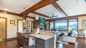 A spacious kitchen with granite countertops, a large island, and a stone backsplash. - Chalakee Lodge CF-2- Mountain View, Gated Resort, Indoor/Outdoor Pools & Hot Tub (Boone)