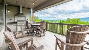 An outdoor deck with a grill and seating area, overlooking a scenic landscape. - Chalakee Lodge CF-2- Mountain View, Gated Resort, Indoor/Outdoor Pools & Hot Tub (Boone)