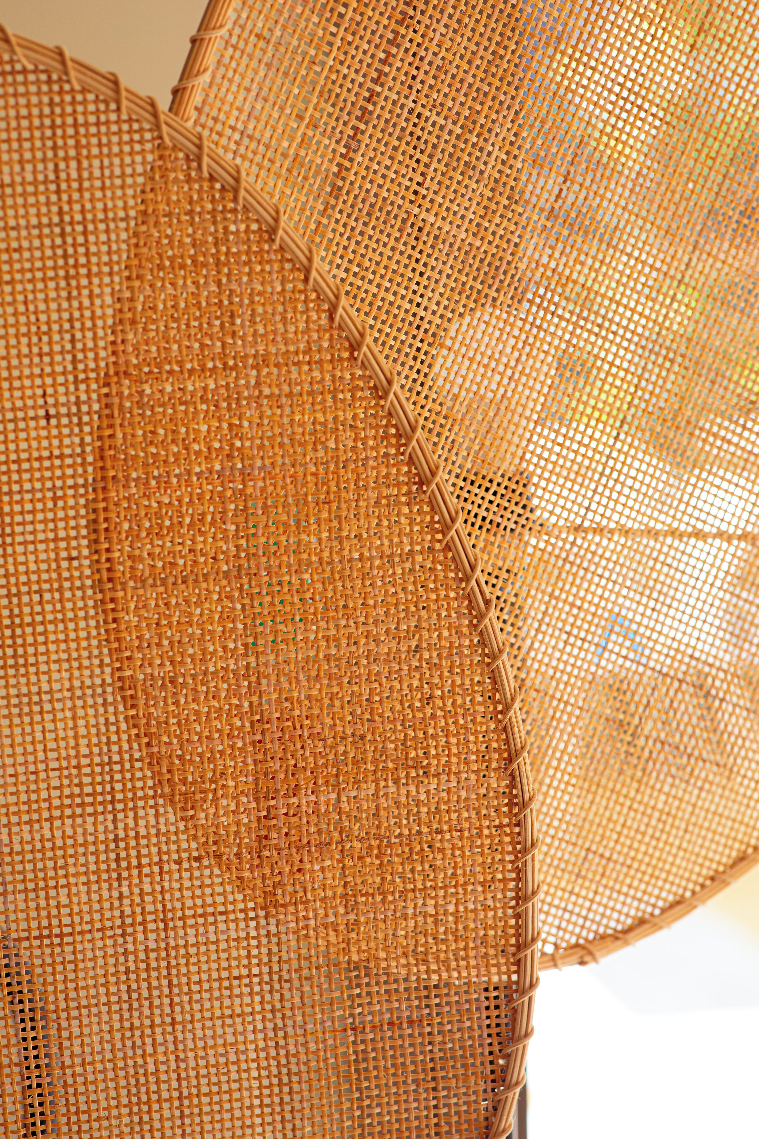 A close-up of a woven basket with a circular shape and a braided edge.