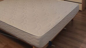 A mattress with a patterned top and a wooden frame. - Apartment terasse Le Barcarès  (Le Barcarès)