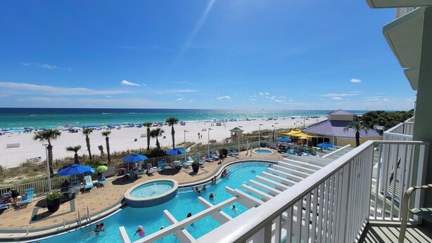 A pool area with multiple swimming pools, lounge chairs, and umbrellas. - Family-Friendly Condo, Amenities Galore (Panama City Beach)