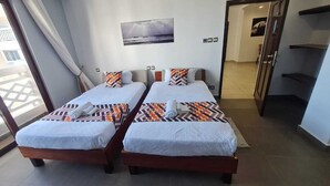 A hotel room with two beds, a large window with curtains, a painting on the wall, and a view of the outside. - Luxury Beachfront Apartments (Mombasa)