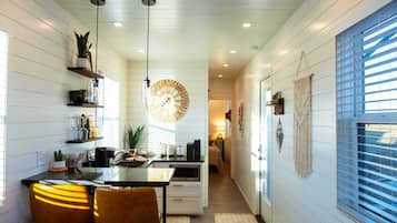 Fridge, microwave, coffee/tea maker, cookware/dishes/utensils