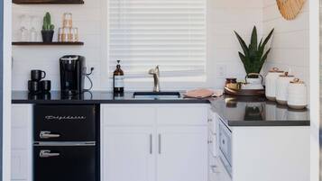 Fridge, microwave, coffee/tea maker, cookware/dishes/utensils