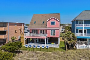 A two-story house with a balcony and a pool area. - Sandy Toes: Oceanfront Home w/ Pool & Pet Friendly (North Myrtle Beach)