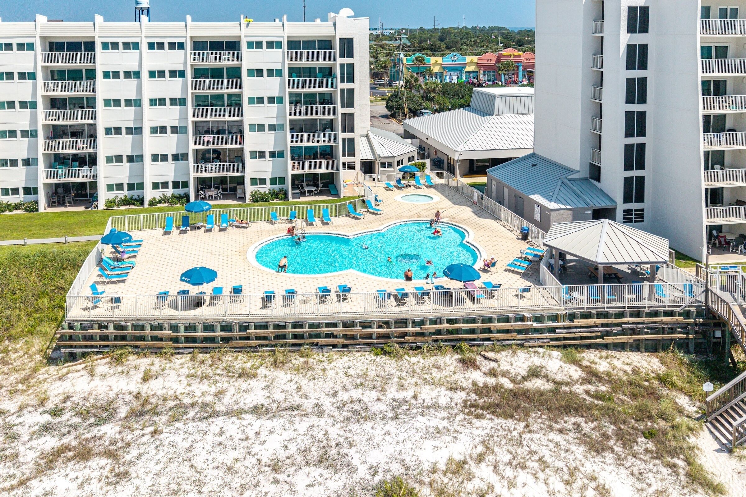 A multi-level hotel with a pool area, including sun loungers and a children's pool.