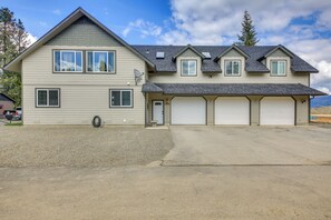 A two-story house with a garage, a driveway, and a satellite dish. - Beachfront Sagle Retreat w/ Boat Dock & Lift (Sagle)