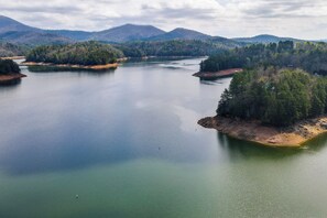 A large body of water surrounded by forested hills. - Fire Pit + Community Perks: Murphy Family Cabin! (Murphy)