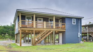 A two-story house with a balcony, wooden staircase, and a covered porch area. - 'dularge Copper Landing' - Steps to Falgout Marina (Theriot)