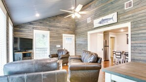 A living room with leather sofas, a wooden ceiling, and a dining area with a table and chairs. - 'dularge Copper Landing' - Steps to Falgout Marina (Theriot)