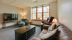 A living room with a television, sofa, and coffee table. - Pet-friendly New Kensington Apt w/ Shared Perks (New Kensington)