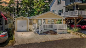 A two-story house with a front porch, a garage, and a small deck. - 1654 Ocean Lakes Pet Friendly Golf Cart⛱️🏝️🩱🌊👙☀️🐚 (Myrtle Beach)