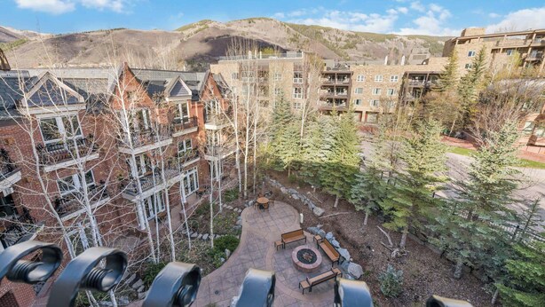 A courtyard with a fire pit, benches, and a view of surrounding buildings. - The Aspen Mountain Residences 49AB - 2 Bedroom Residence (Aspen)