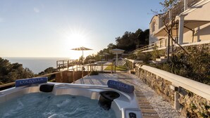 A hot tub with 'L'Olivella' branding, a wooden deck, and a view of the sea. - Villa Maiuri by MyVillaCollection (Anacapri)