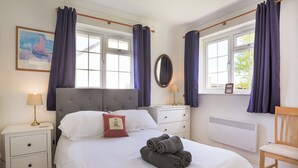A neatly arranged bedroom with a bed, bedside tables, a dresser, and a chair. - 4 bedroom accommodation in Rock (Rock)