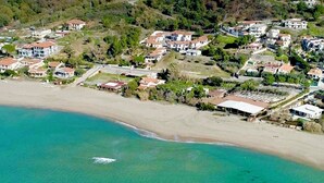 An aerial view of a coastal residential area with houses, a beach, and a boat on the water. - Orizzonte Blu Superior 11, Palinuro, Cilento (Palinuro)