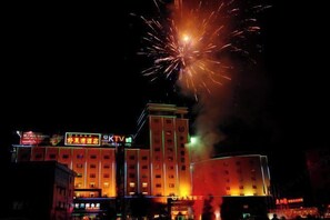 A hotel with multiple floors and illuminated signage, including a prominent KTV sign. - Haolaiwan Hotel (Luoding)