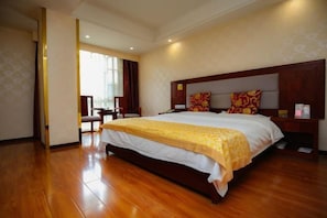 A spacious hotel room with a large bed, wooden flooring, and a view of the outdoors. - Haowanjia Hotel (Kunming)