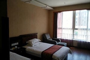 A hotel room with two beds, a chair, a desk, and a large window with a view. - Daishan Xiushan Hotel (Daishan)