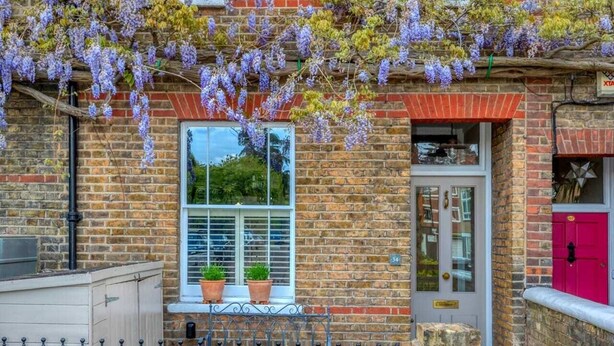 A brick building with a sign reading "Woodbine Cottage 1875". - 3-bedroom Home in Richmond - Ideal Family Living (London)