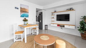 A modern kitchen with white cabinetry, a built-in microwave, and a stainless steel refrigerator. - Beach Break Two - One Bedroom Apartment, Sleeps 2 (Cape Town)