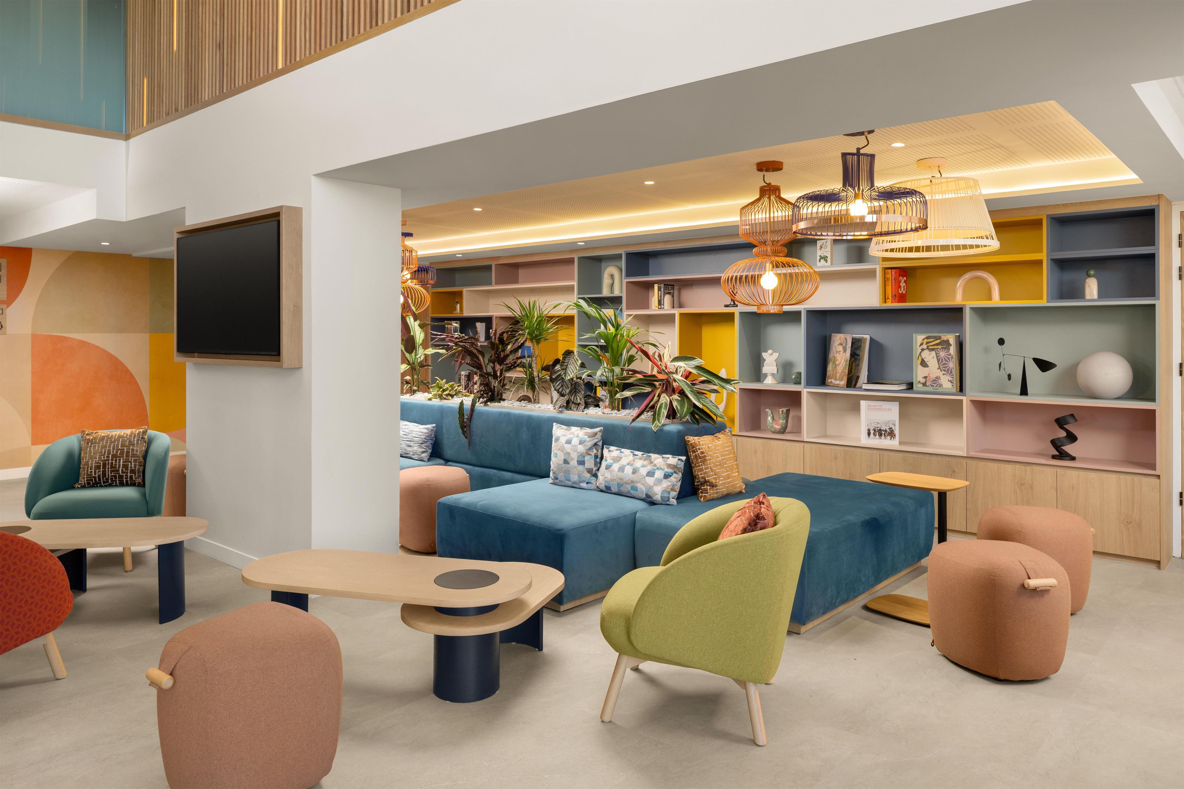 A modern lounge area with a sofa, chairs, and a coffee table.