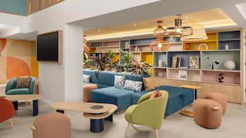 A modern lounge area with a sofa, chairs, and a coffee table.