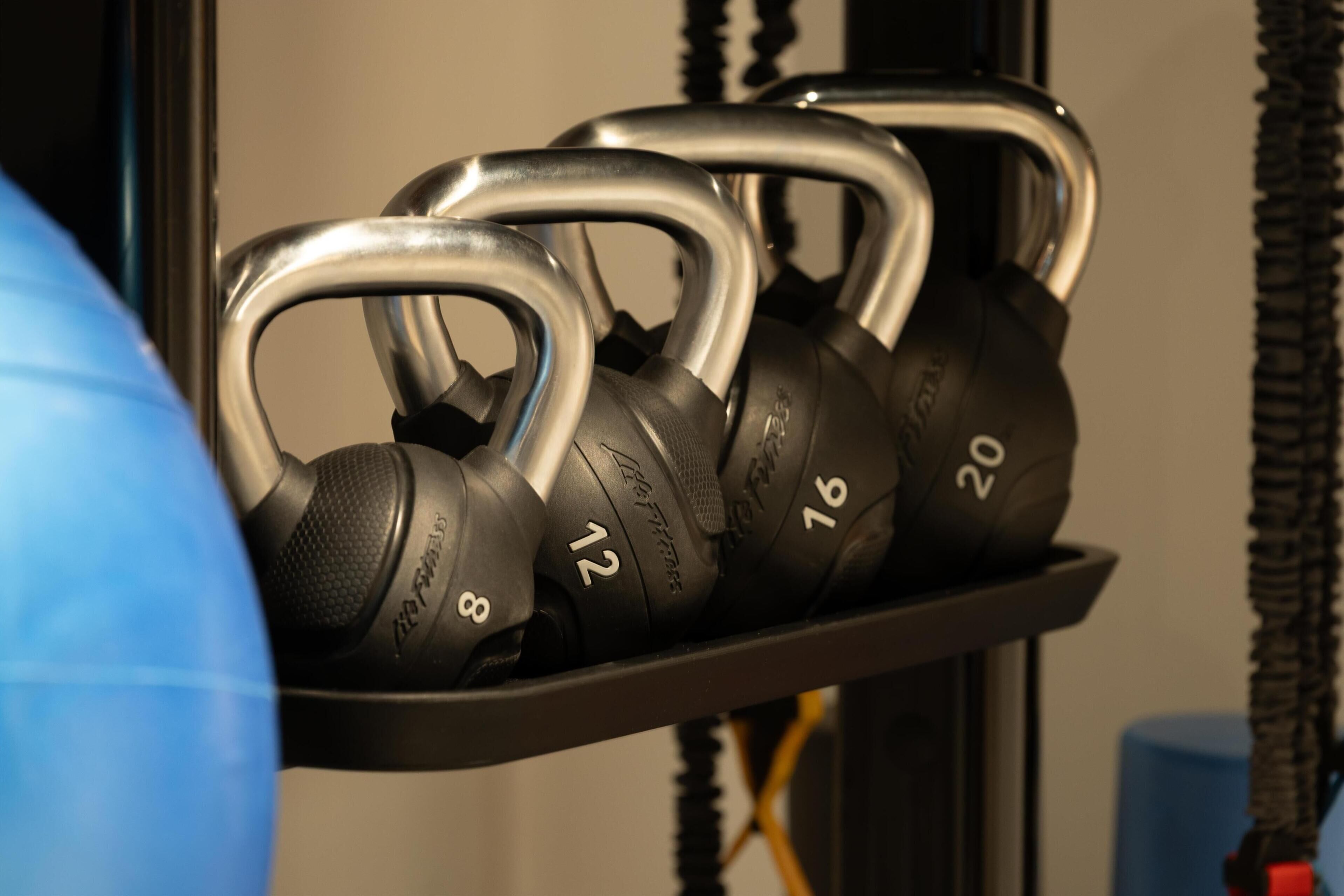 A rack of kettlebells with weights ranging from 8 to 20.