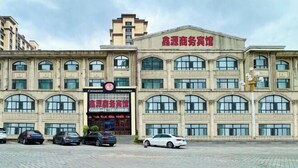A multi-story building with a prominent sign indicating it is a business hotel.