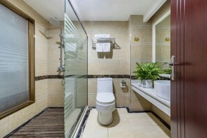 A modern bathroom with a glass-enclosed shower, a toilet, a sink, and a potted plant. - Fuzhicheng Boutique Hotel (Yuantan Railway Station Branch) (Qingyuan)