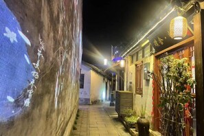 A narrow alleyway with traditional architecture, including a tiled wall and wooden doors. - Pushe Guiyin Inn (Kunshan)