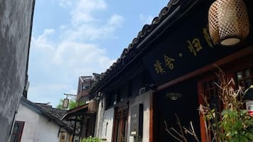 A traditional building with a tiled roof and a hanging lantern.