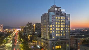 A high-rise hotel with multiple floors, large windows, and a prominent sign at the top.
