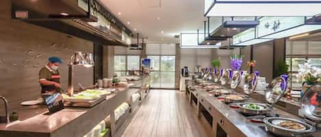 A buffet setup with multiple food stations and a long counter.