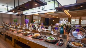 A buffet setup with various food items and decorative elements. - PULUN HoTEL (Cixi Wuyue Plaza) (Cixi)