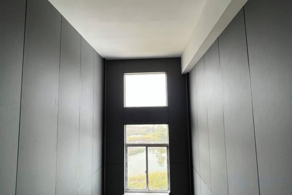 A narrow room with a window and a door.