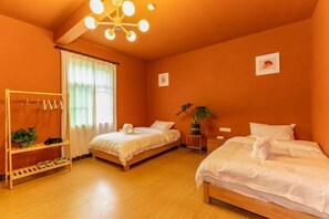 A room with two beds, a wooden wardrobe, a plant, and a ceiling light fixture. - Shenzhen Xinghai Xiaoye Inn (Shenzhen)