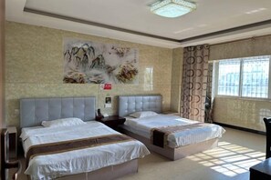 A hotel room with two beds, a large painting on the wall, and a window with curtains. - hlkz (Xiuning)