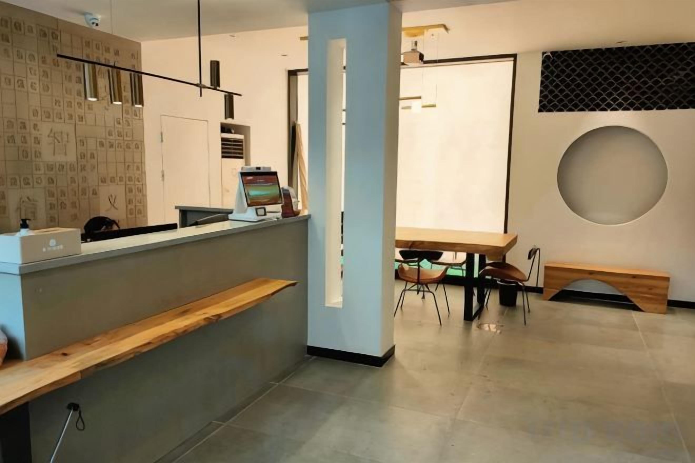 A reception area with a counter, seating, and a large window.