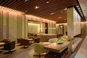 A modern interior with a central seating area, a bar, and a large mirror. - Jinjiang Inn Select (Lushan City)