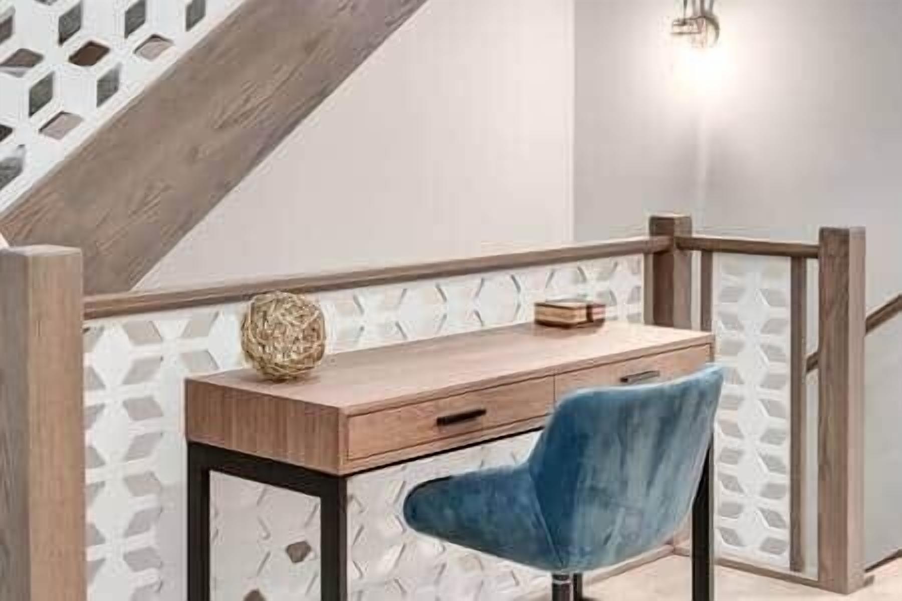 A wooden desk with a blue chair, a woven ball, and a book on it.