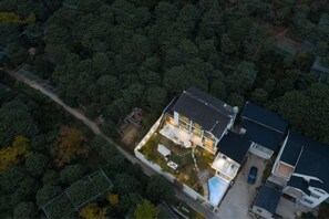 An aerial view of a residential property with a swimming pool, a covered patio, and a fenced yard. - Carefree Valleys (Suzhou Qiyuan Road Store) (Suzhou)