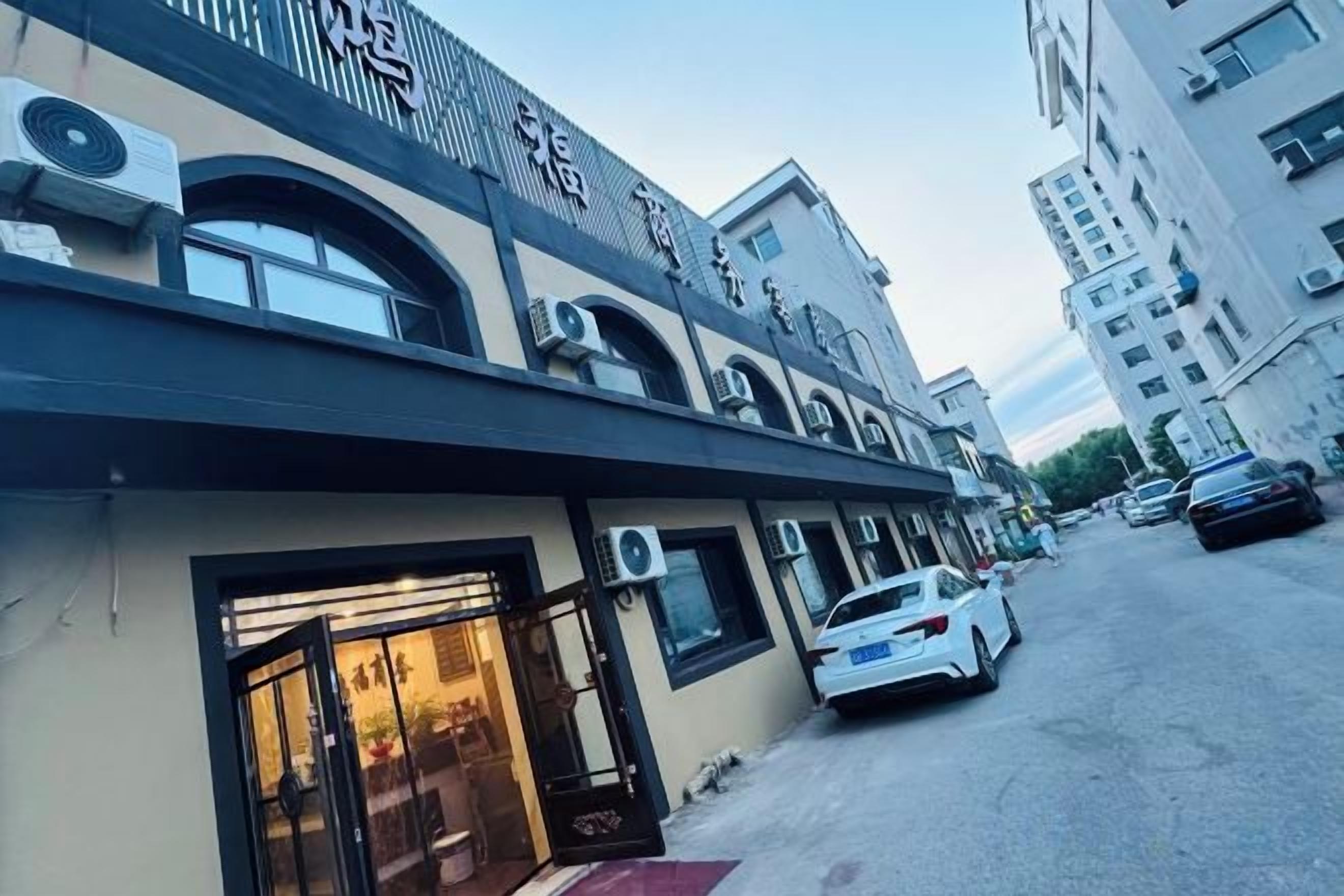A building with a storefront and a parking area.