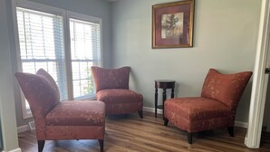 A room with two armchairs, a small table, and a window with blinds. - Cozy Chippewa Lake Ranch just steps from the lake! Kayaks and SUPs Private beach (Chippewa Lake)