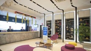 A hotel reception area with a counter, seating, and a large window. - Lavande Hotel Wuhan Wujiashan 5th Ring Sports Center (Wuhan)