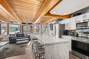 Enjoy cooking in the spacious kitchen with a large island, double oven, and refrigerator, plus a comfortable seating area.