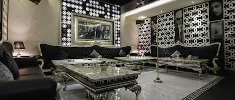 A luxurious room with a large window, ornate furniture, and decorative wall panels.