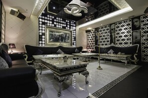 A luxurious room with a large window, ornate furniture, and decorative wall panels. - Rich Forex Hotel (Foshan)